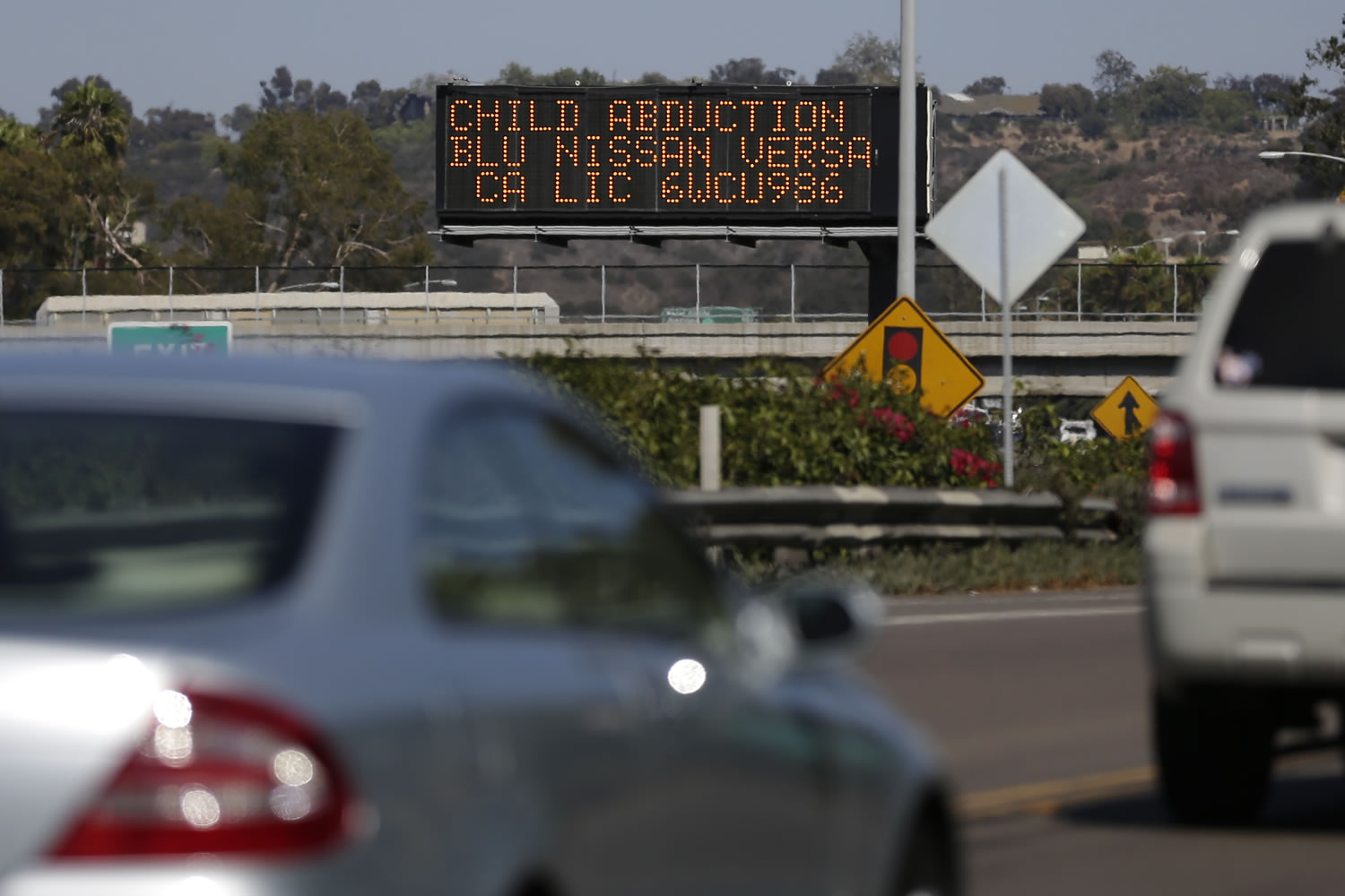 Drivers pass a display showing an Amber Alert, asking motorists to be on the lookout for a specific vehicle Tuesday in San Diego.