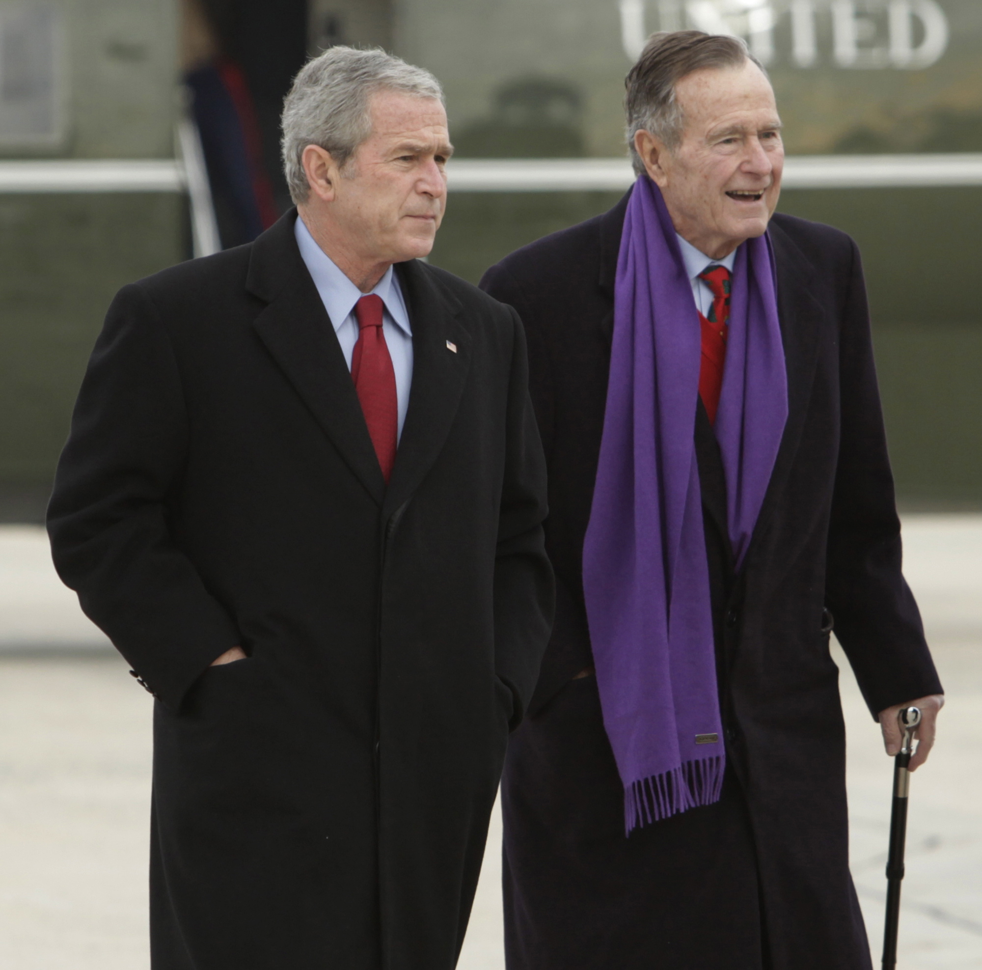 President George W. Bush walks with his father, President George H.W.