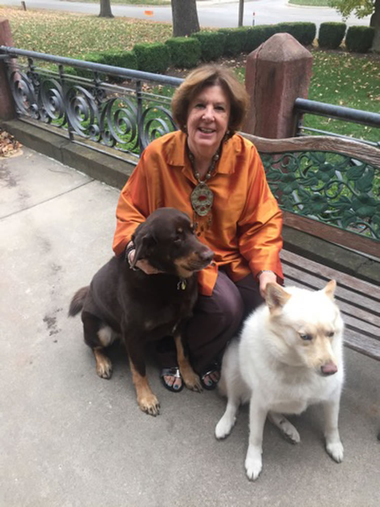 Gayle Krigel poses with her dogs Mousse, left, and Shanny in Kansas City, Mo. As baby boomers age, their relationships with their pets can benefit both the people and the animals.