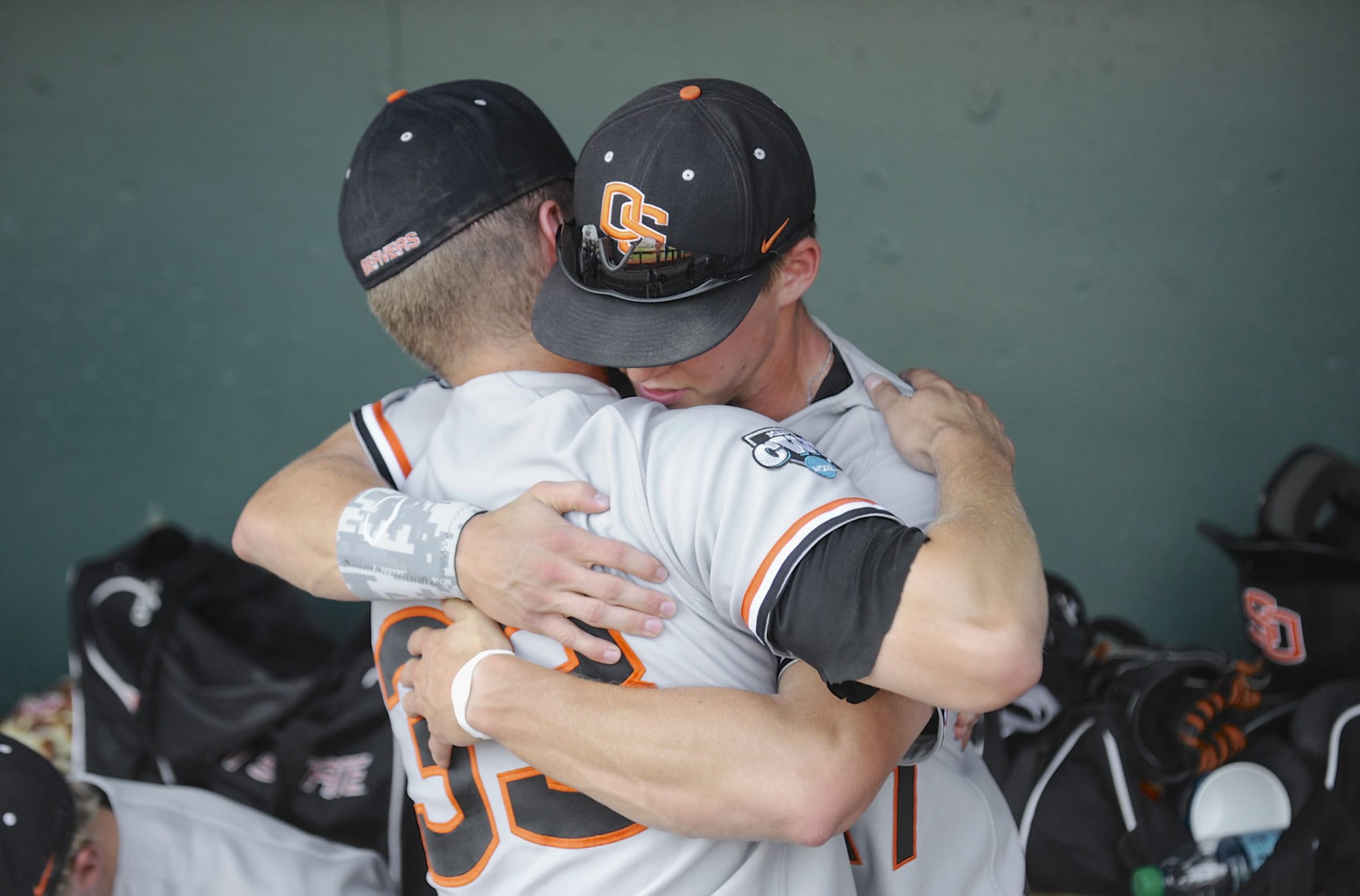 Oregon State's Ryan Barnes (33) and Joey Jansen hug after losing 4-1 to Mississippi State on Friday.