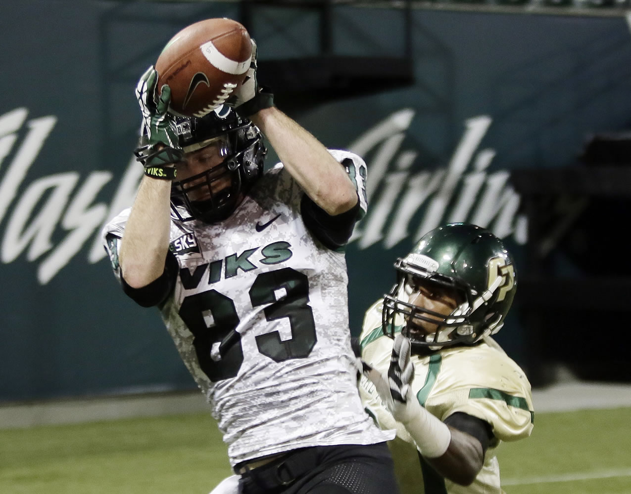 Portland State wide receiver Alex Toureen (83) hauls in a touchdown pass against Cal Poly defender Karlton Dennis during the first half Thursday.