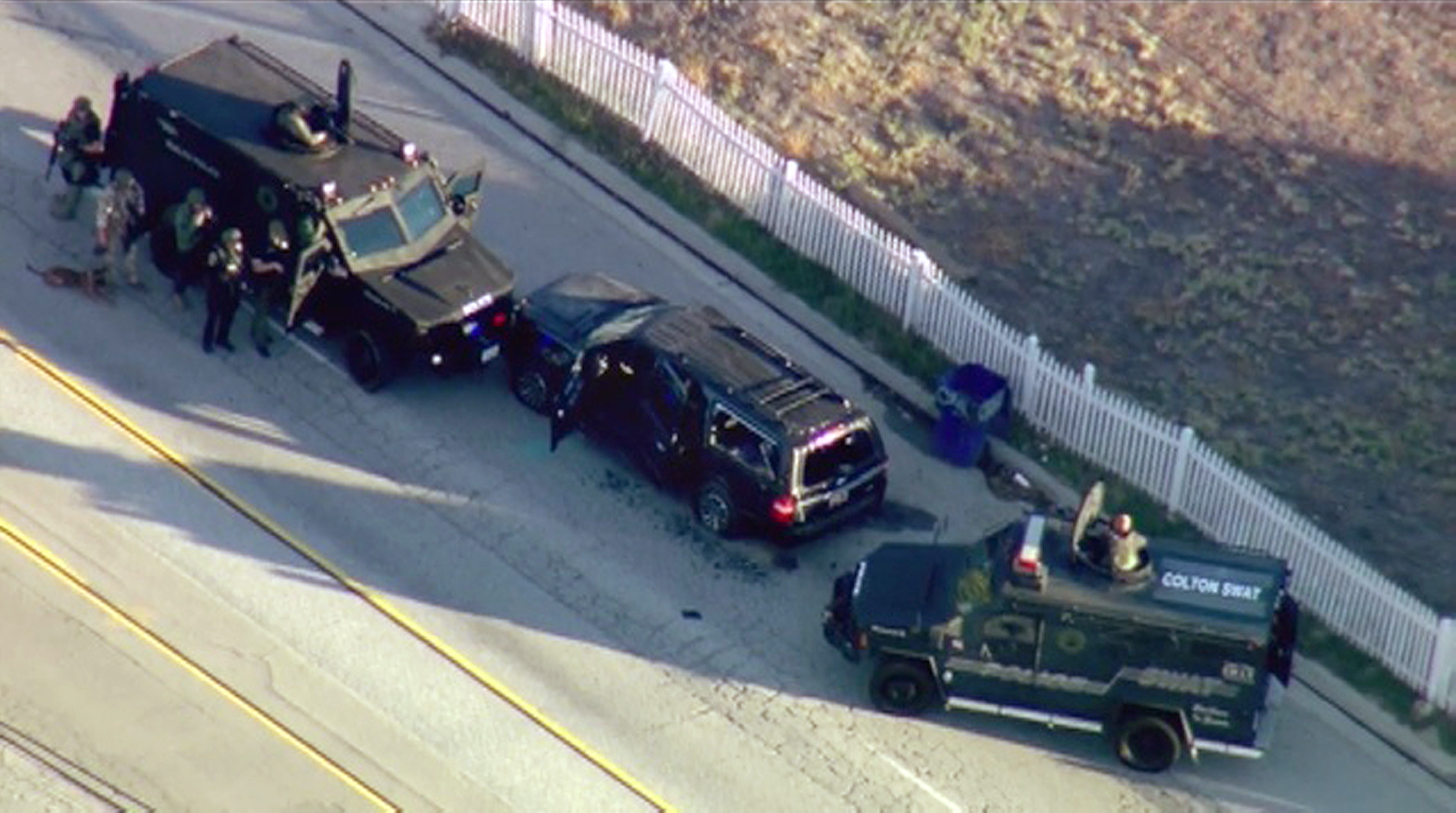 Armored vehicles surround an SUV following a shootout Wednesday in San Bernardino, Calif. The scene followed a military-style attack that killed 14 people and wounded more than a dozen others at a California center that serves people with developmental disabilities, authorities said.