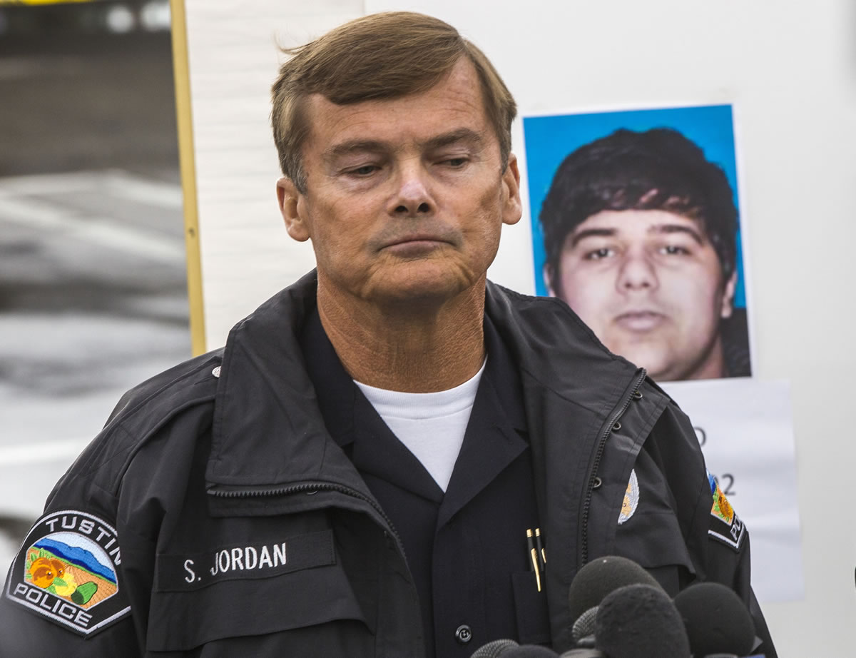 Tustin Police Chief Scott Jordan takes questions about suspected gunman, Ali Syed, pictured behind Jordan, on Tuesday in Tustin, Calif.