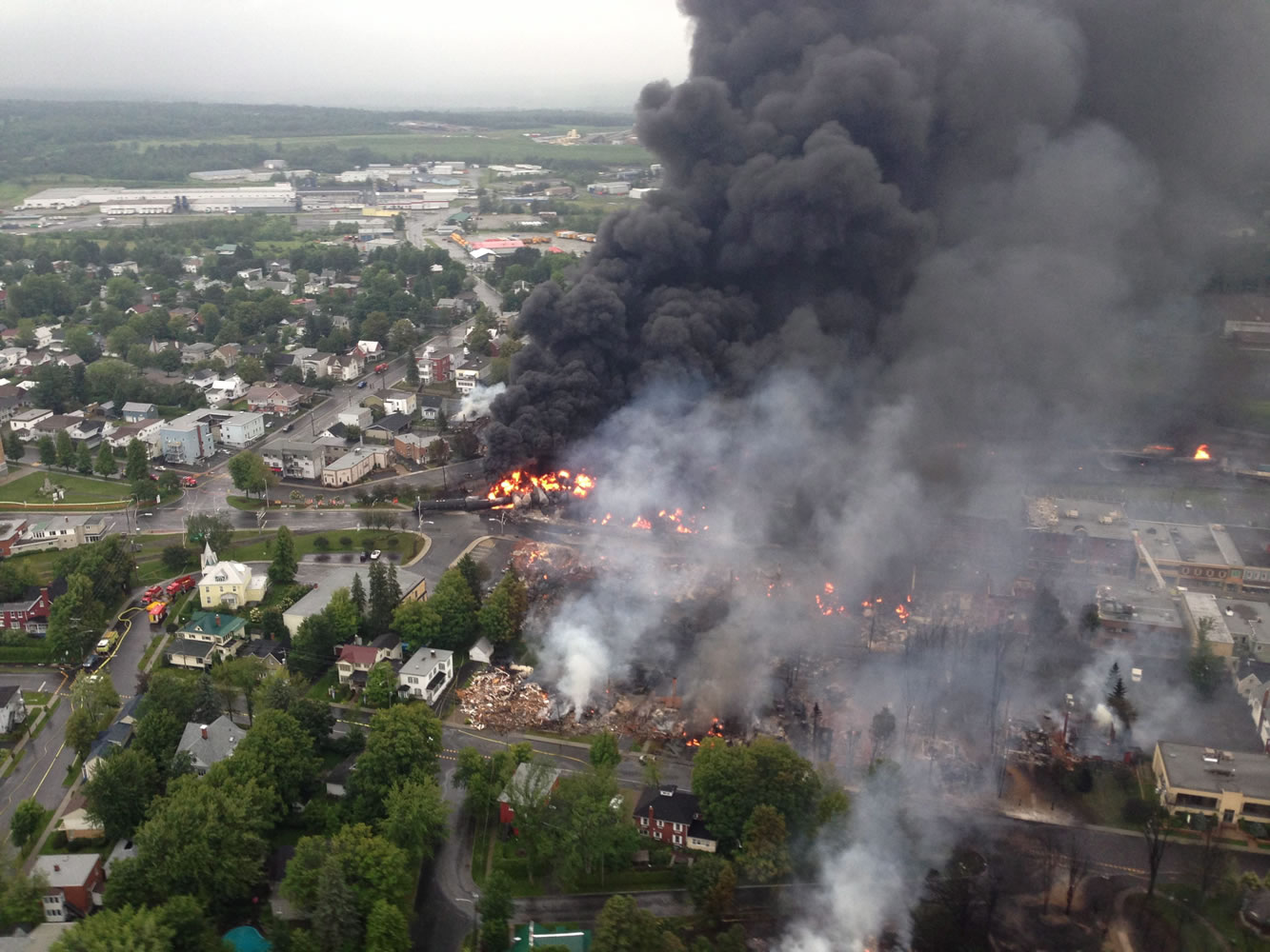 An aerial view of a fire in the town of Lac-Megantic is seen from a Surete du Quebec helicopter Saturday following a train derailment the sparked several explosions in Lac Megantic, Quebec.