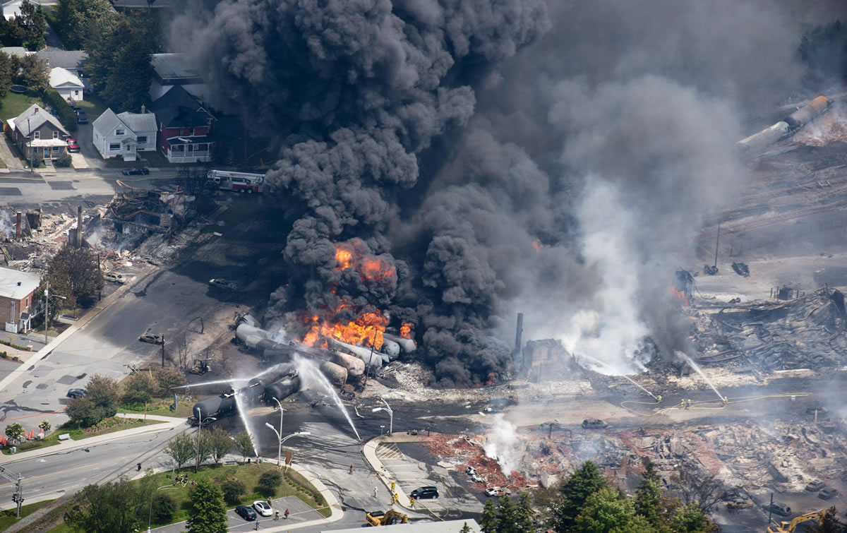 Smoke rises from railway cars Saturday that were carrying crude oil after derailing in downtown Lac Megantic, Quebec, Canada.