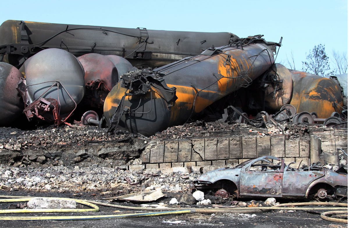 This photo provided by Surete du Quebec, shows wrecked oil tankers and debris  from a runaway train on Monday, July 8, 2013 in Lac-Megantic, Quebec, Canada.  A runaway train derailed igniting tanker cars carrying crude oil early Saturday, July 6.  At least thirteen people were confirmed dead and nearly 40 others were still missing in a catastrophe that raised questions about the safety of transporting oil by rail instead of pipeline.