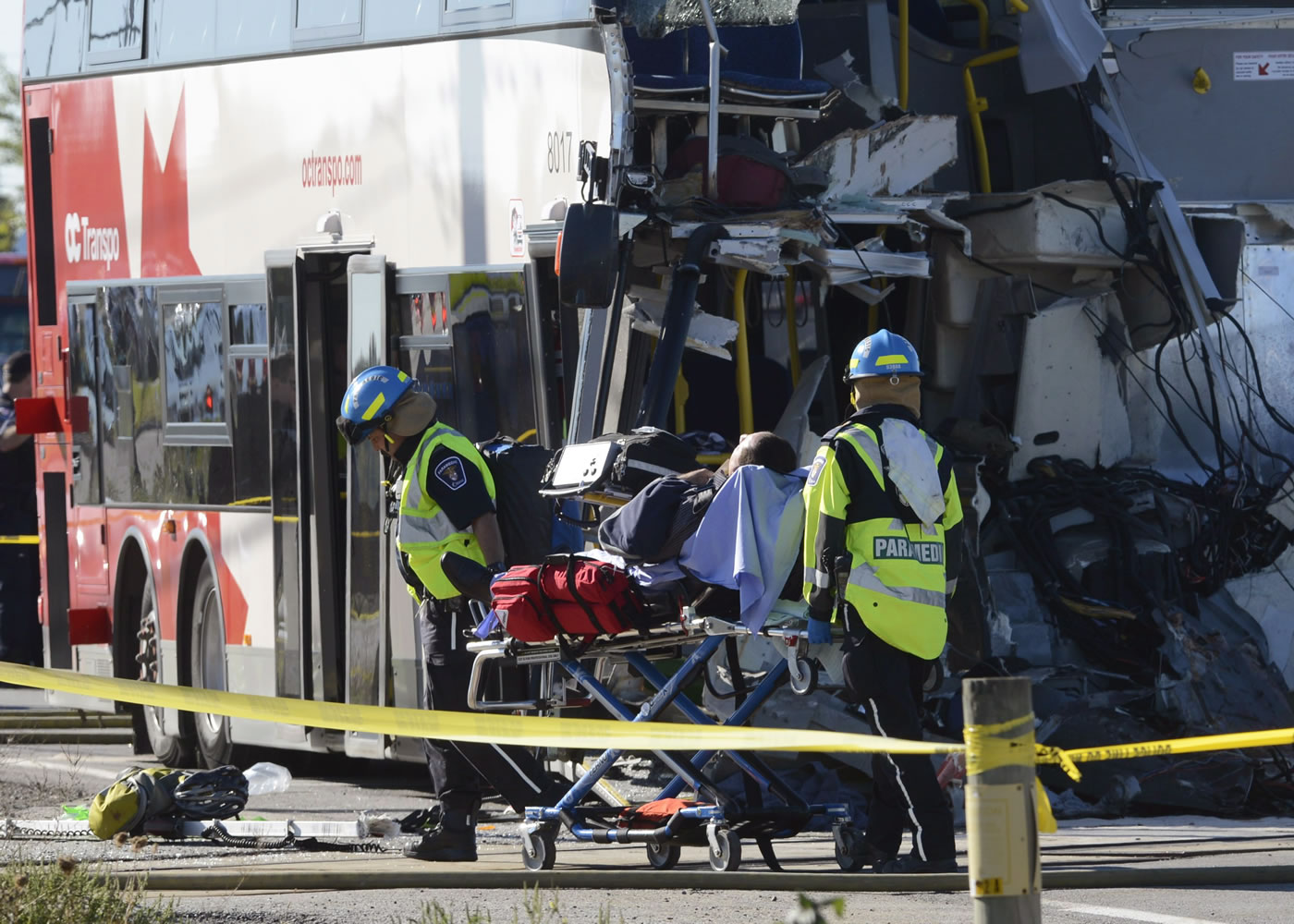 A passenger is taken from the scene of a Via Rail train and city bus collision in Ottawa's west end Wednesday.