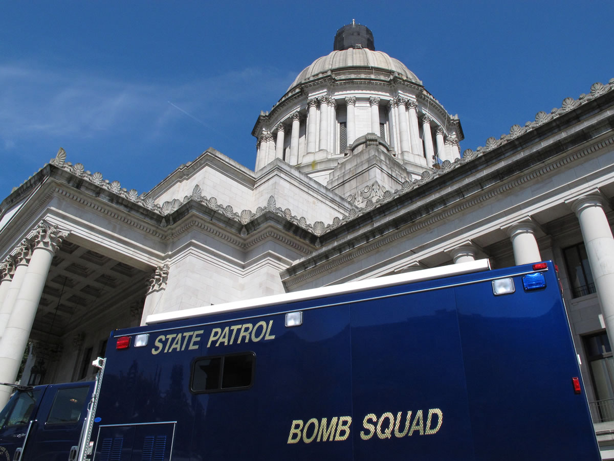 Associated Press files
A bomb squad truck is parked outside the Washington state Capitol in Olympia on Aug. 13 during an evacuation prompted by a suspicious package left in the rotunda.