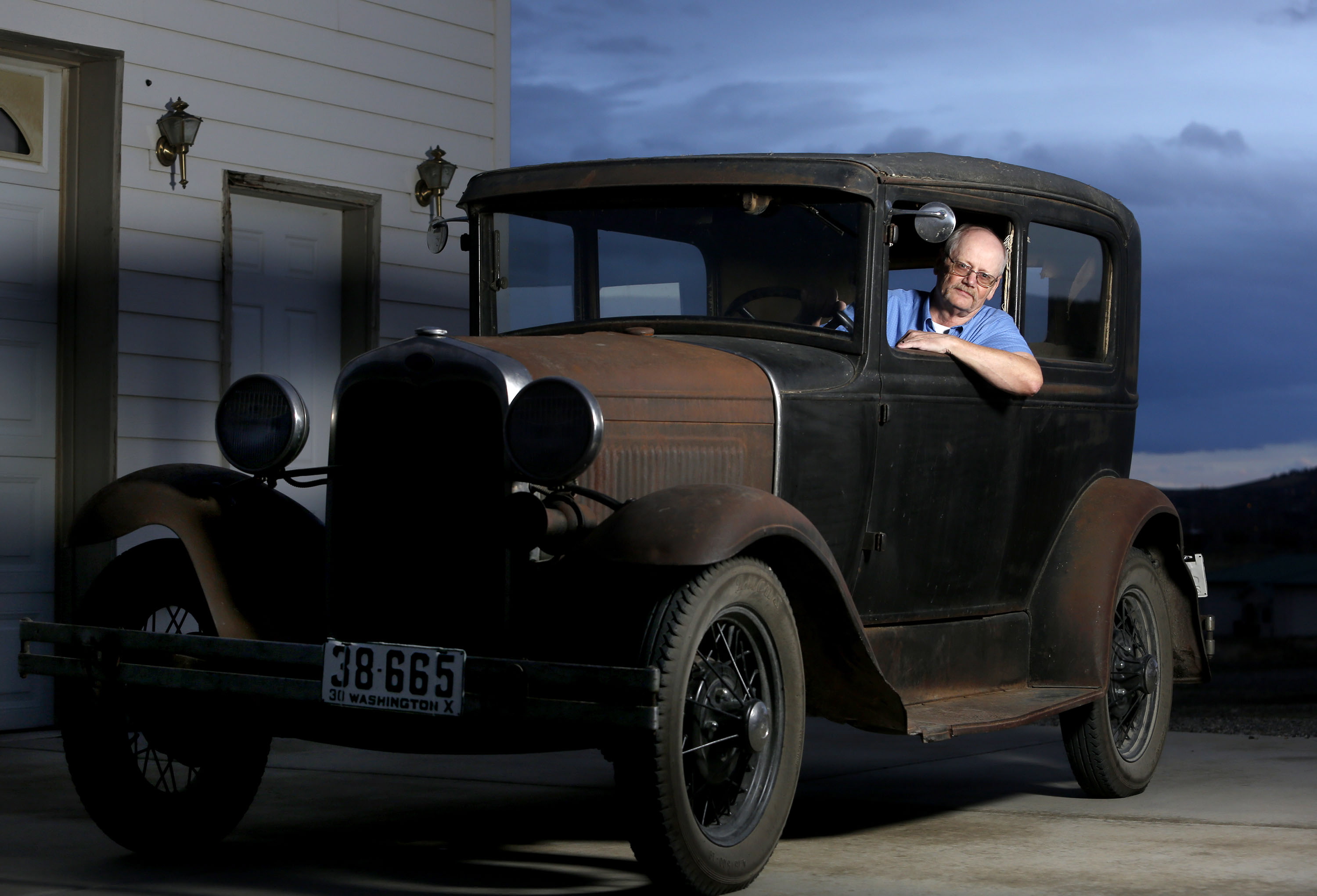 Tom Eldhardt sits in his 1930 Ford Model A Tudor at the shop where he works on cars outside his home in West Richland. Eldhardt is featured in the December issue of Hemmings Classic Car, a magazine aimed at car collectors.