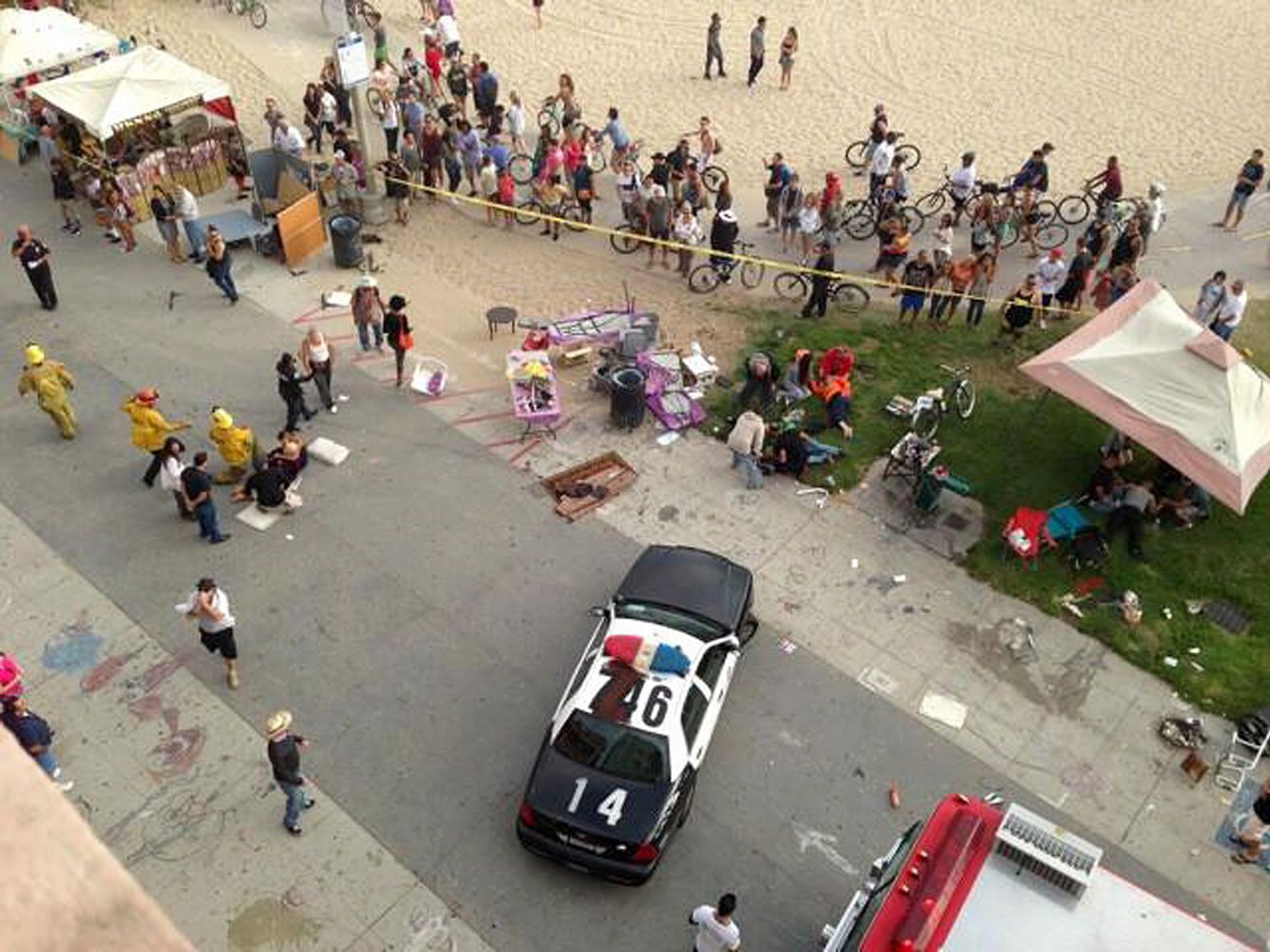 Pedestrians gather as police and fire officials respond Saturday to the Venice Beach boardwalk in Los Angeles, where a car drove through a packed afternoon crowd.
