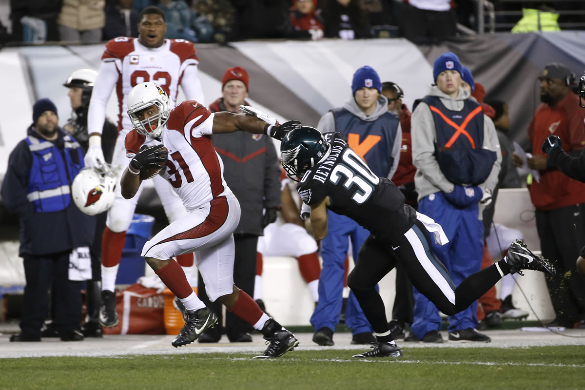 Arizona Cardinals' David Johnson, left, breaks free of Philadelphia Eagles' Ed Reynolds on a touchdown run during the first half of an NFL football game, Sunday, Dec. 20, 2015, in Philadelphia.