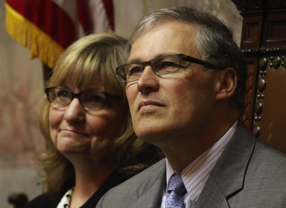 As the special session nears its end, Gov. Jay Inslee and wife Trudi Inslee are seen on the floor of the Washington Senate on Monday in Olympia during a memorial for the late Sen.