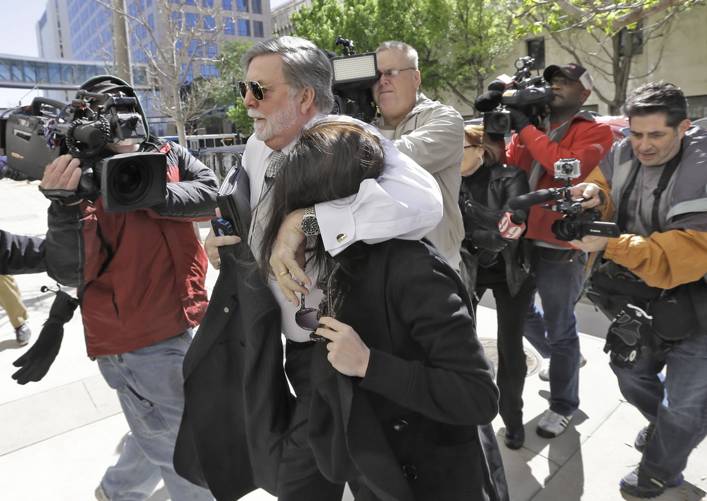 Casey Anthony is protected from the media by her attorney, Cheney Mason, as she arrives at the United States Courthouse for a bankruptcy hearing Monday in Tampa, Fla.