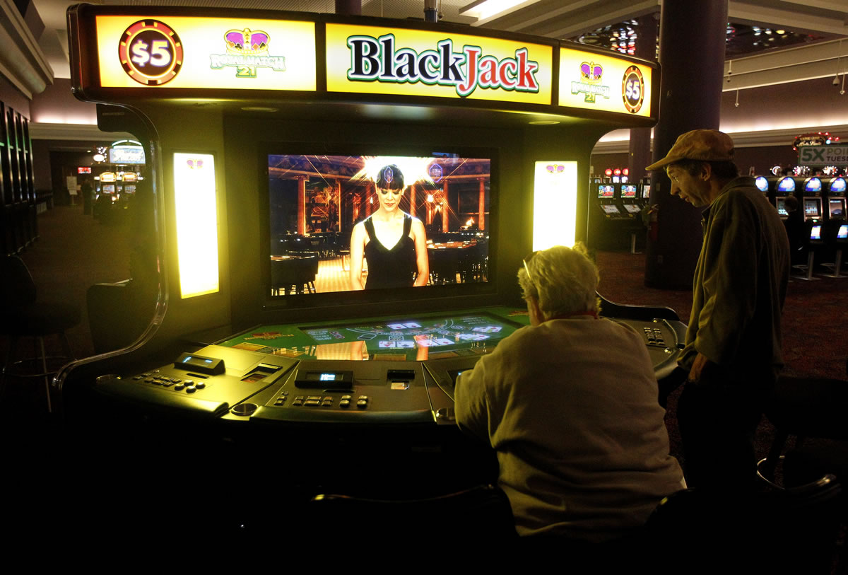 Patrons play at an electronic Blackjack table at the Newport Grand slot parlor in Newport, R.I. Voters in Rhode Island, Oregon and Maryland will decide Nov.