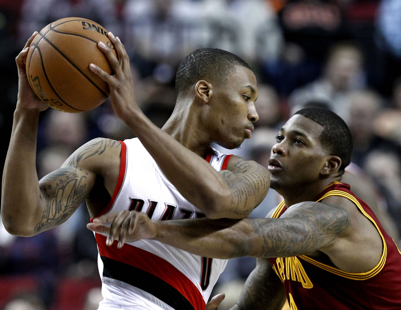 Cleveland Cavaliers forward Alonzo Gee, right, pressures Portland Trail Blazers guard Damian Lillard during the first quarter of an NBA basketball game in Portland, Ore., Wednesday, Jan. 16, 2013.