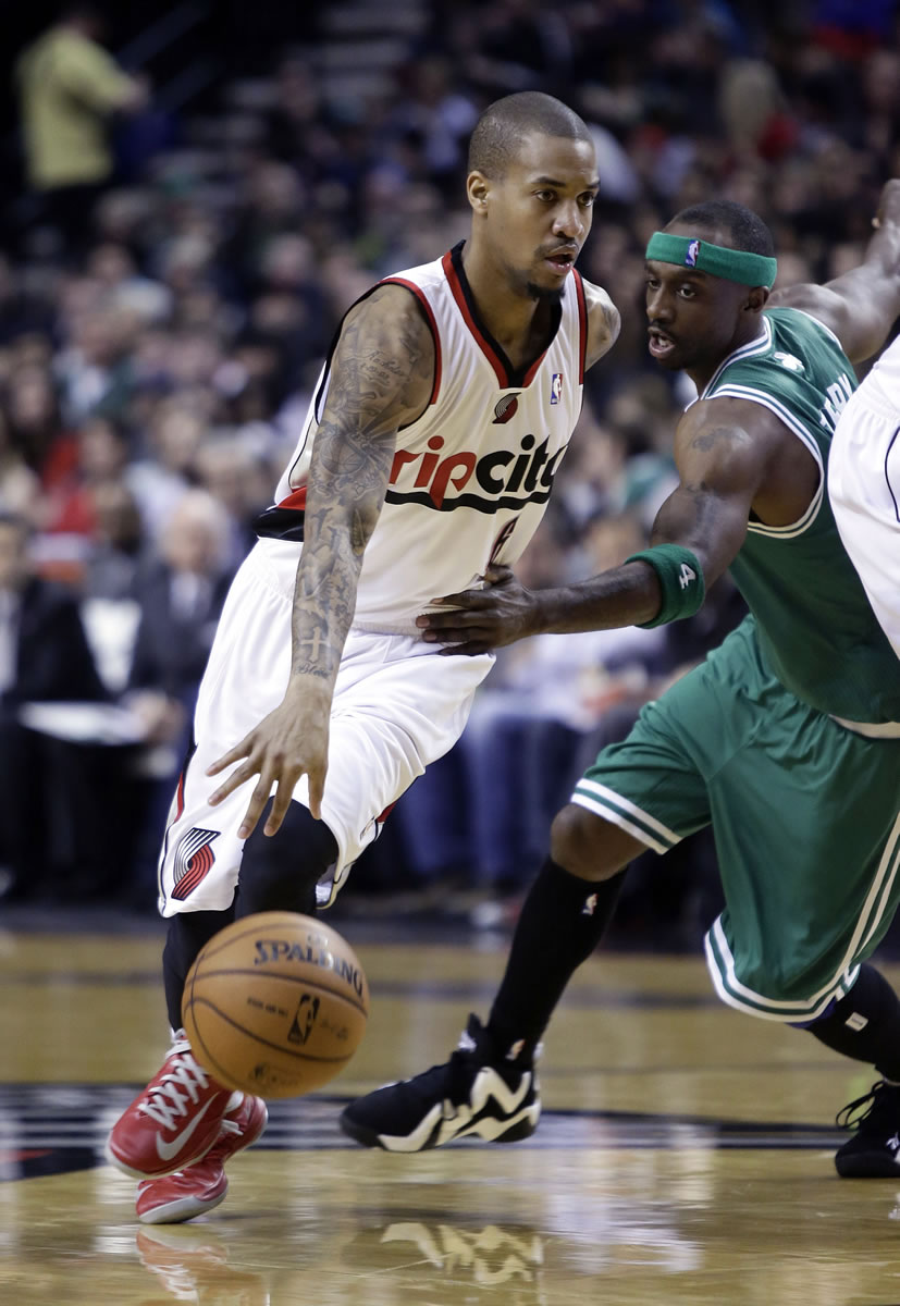 Portland Trail Blazers guard Eric Maynor, left, drives to the basket past Boston Celtics guard Jason Terry during the second half Sunday.