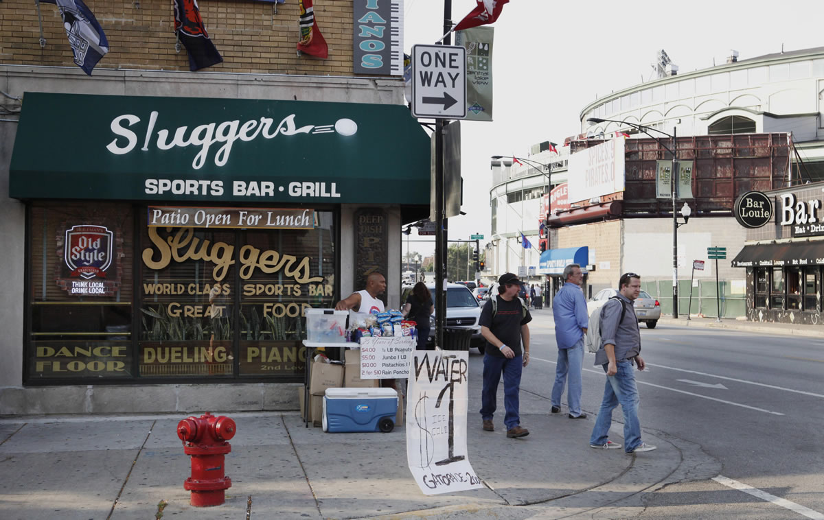 Sluggers Sports Bar and Grill near Wrigley Field, background, before a Chicago Cubs baseball game in Chicago.