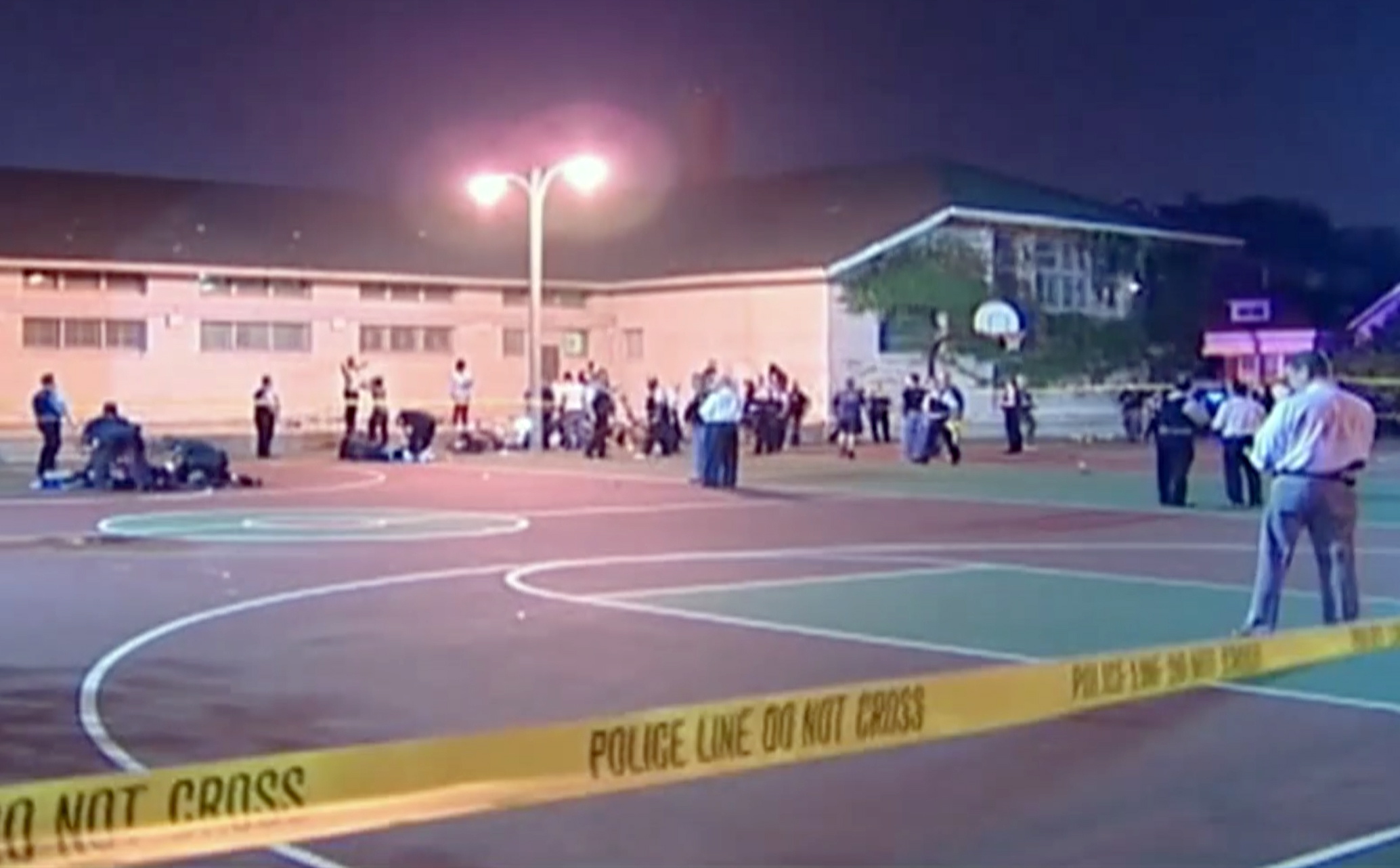 This still frame made from a video provided by Ken Herzlich shows the scene where a number of people, including a 3-year-old child, were shot Thursday night in a city park in Chicago.