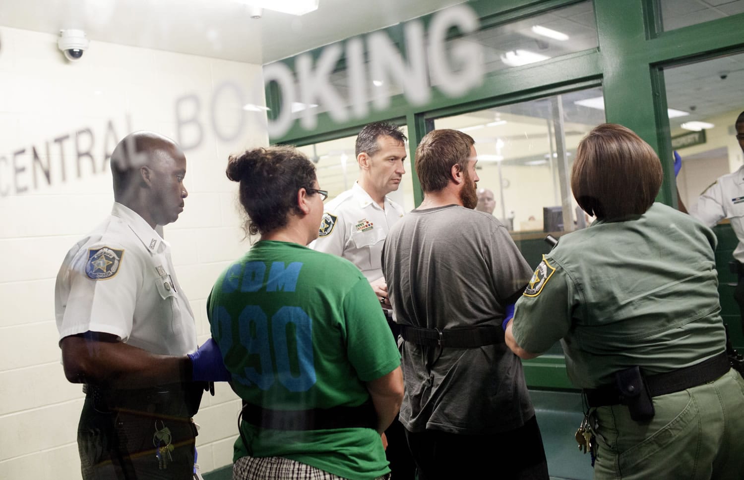 Sharyn Hakken, second from left, and Joshua Hakken, are taken into booking by Hillsborough County Sheriff Officers at the Orient Road Jail after being brought in from Cuba early Wednesday morning.