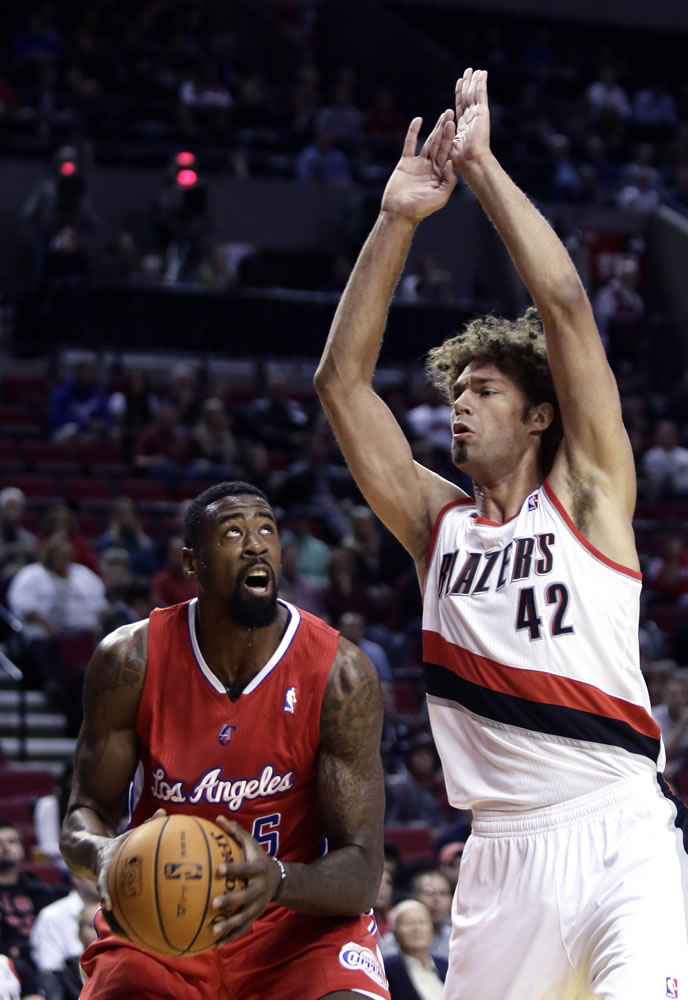 Los Angeles Clippers center DeAndre Jordan, left, looks to shoot as Portland Trail Blazers center Robin Lopez defends during the first half of an NBA preseason basketball game Monday in Portland.