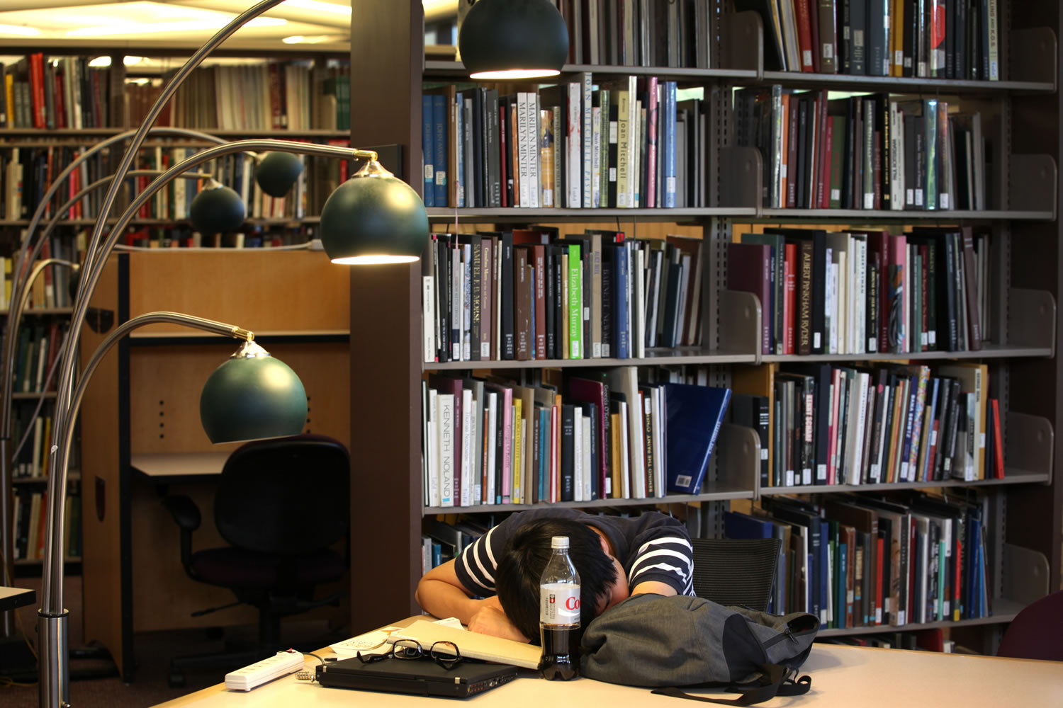 Taewon Kim, an electrical engineering systems graduate student, sleeps in the library at the Duderstandt Center on the campus of the University of Michigan, in Ann Arbor, Mich., in July.