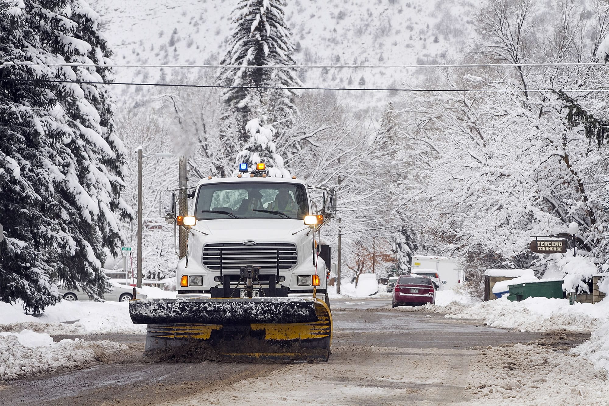 A city plow clears snow along West Third Avenue, Wednesday, Dec. 23, 2015, in Durango, Colo., after a winter storm swept through the region.