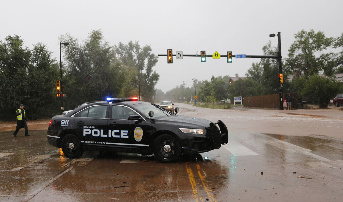 A police officer blocks a closed road following overnight flash flooding, Boulder, Colo., on Thursday.