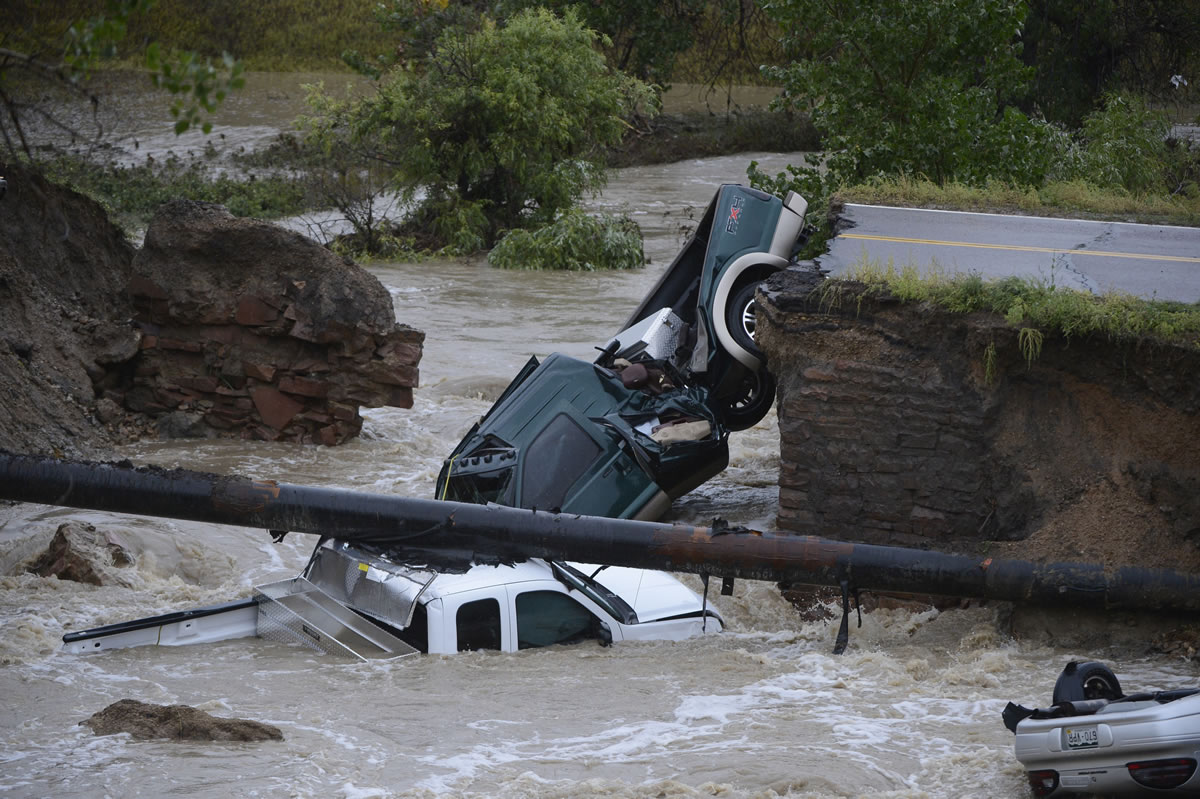 Three vehicles crashed into a creek after the road washed out from beneath them near Dillon Road and 287 in Broomfield Colo., on Thursday in heavy flooding.