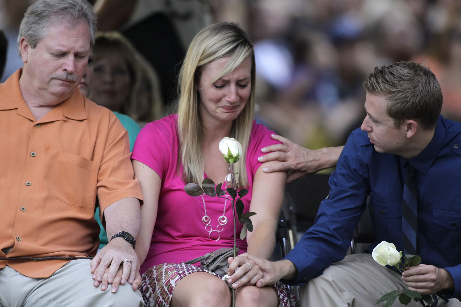 Family members of the victims of Friday's mass shooting in Aurora, Colo., comfort each other Sunday during a prayer vigil for the victims.