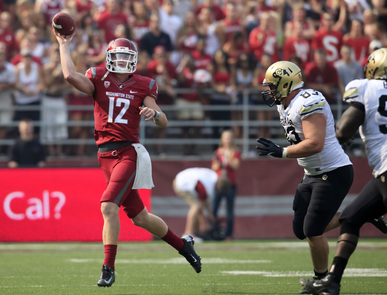 Washington State quarterback Connor Halliday (12) throws while pursued by Colorado defensive end Will Pericak (83) and defensive tackle Nate Bonsu during the first quarter Saturday.
