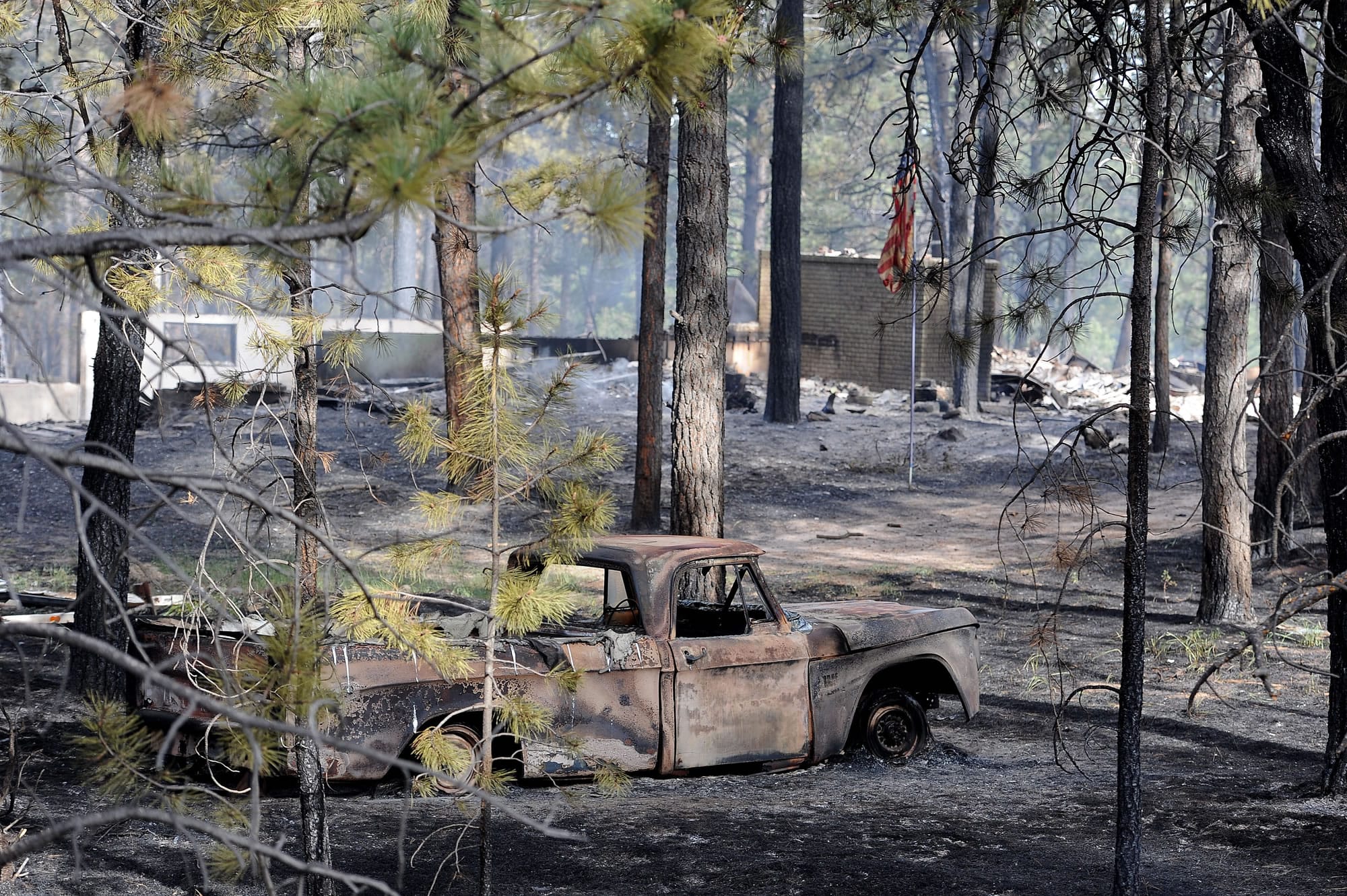 Blackened and charred homes are left along Herring Road in the Black Forest area northeast of Colorado Springs, Colo., on Wednesday.