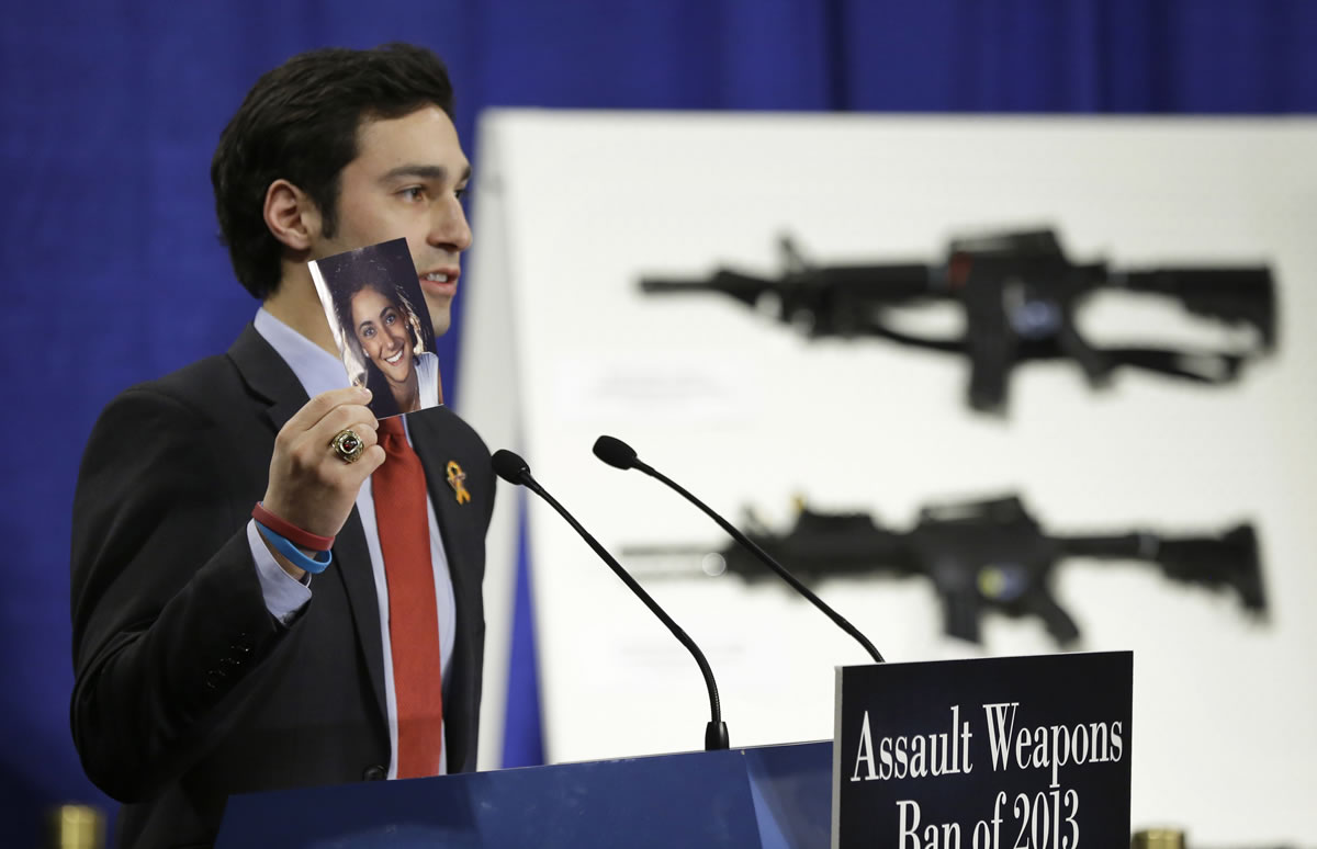 Omar Samaha, holds a picture of his sister Reema Samaha, who was killed in the Virginia Tech shootings, during a news conference on Capitol Hill on Thursday to introduce legislation on assault weapons and high-capacity ammunition feeding devices.