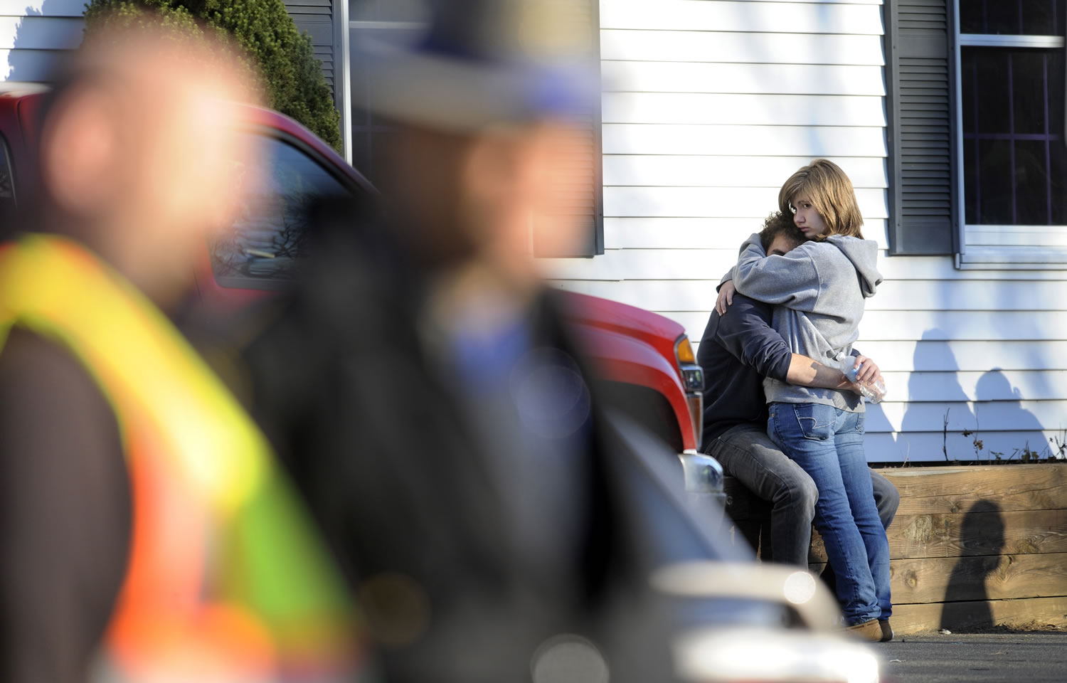 People embrace at a firehouse staging area for family around near the scene of a shooting at the Sandy Hook Elementary School in Newtown, Conn., about 60 miles northeast of New York City on Friday.