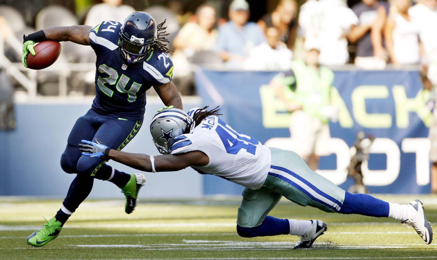 Seattle Seahawks' Marshawn Lynch (24) rushes past Dallas Cowboys' Danny McCray during the second half Sunday.