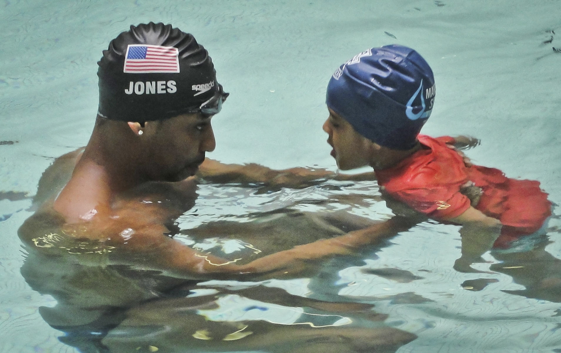 Simone Smalls PR
Olympic gold medalist Cullen Jones give swimming lessons to Niko Diop, a pre-kindergarten student at Harlem's P.S. 125 in New York.