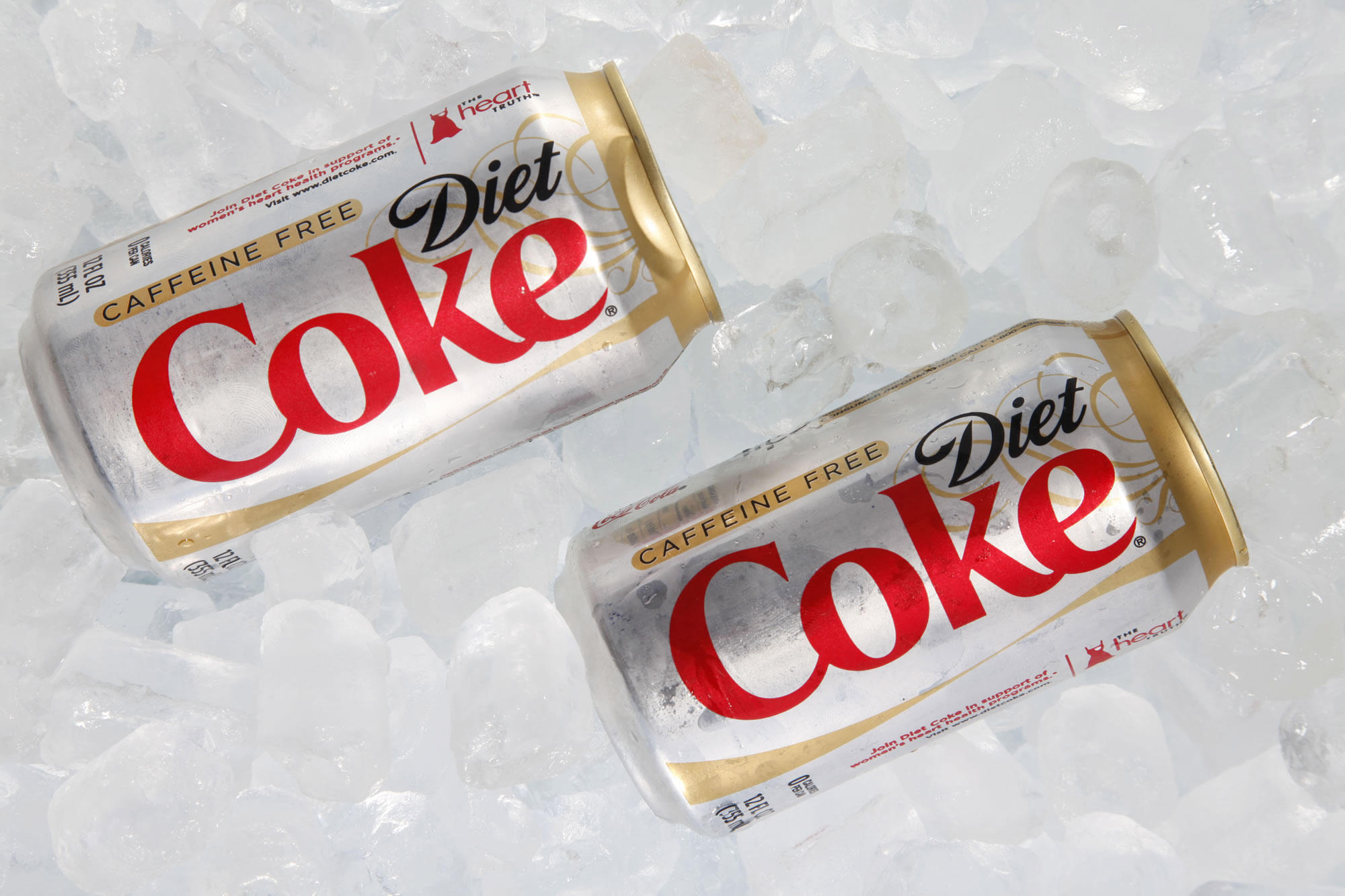 Two cans of Caffeine Free Diet Coke on ice.