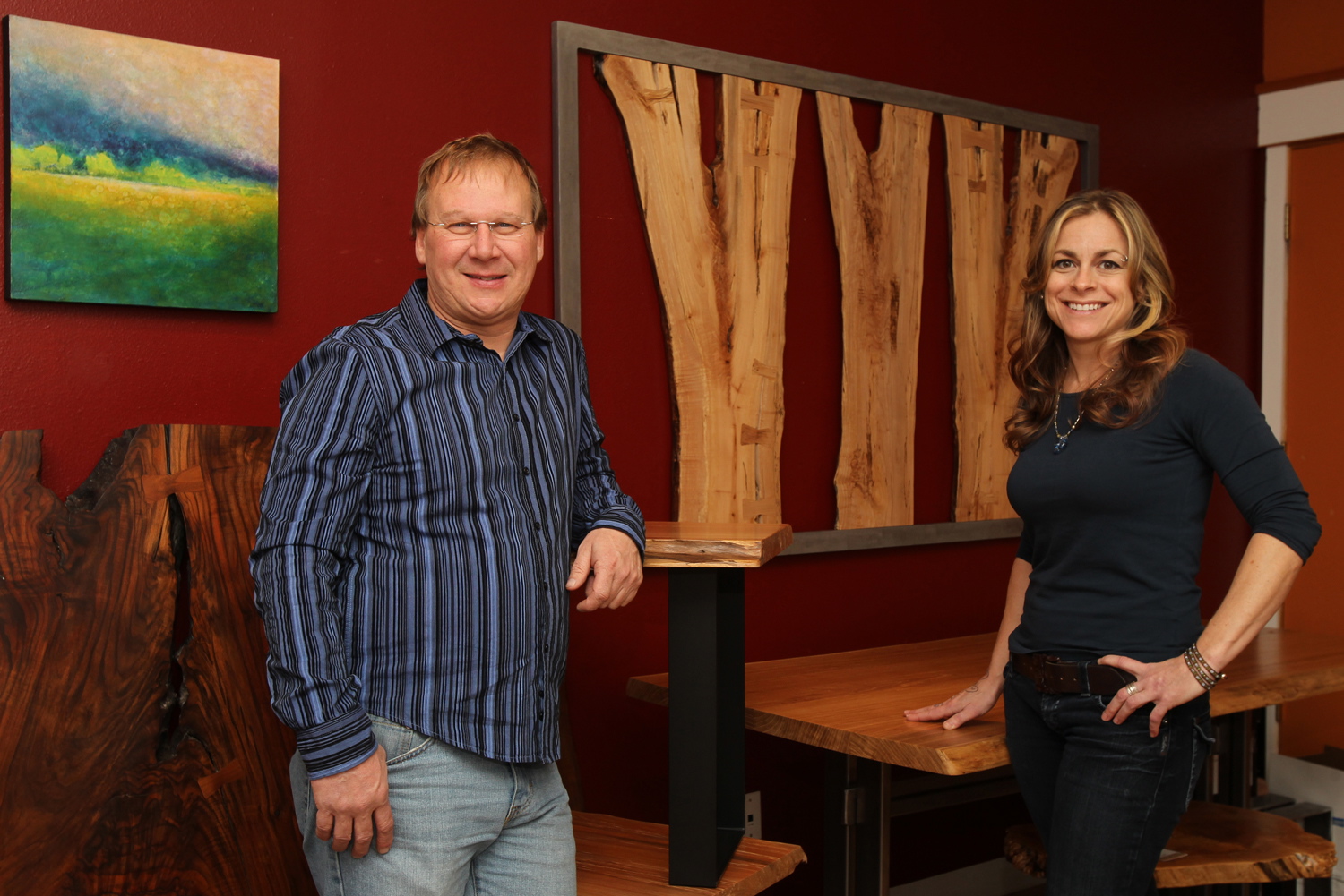 Mike Ross, owner of Natural Edge Furniture, and his sales manager, Renee Van Matre, pose at the company's showroom Feb. 11 in downtown Bend, Ore.