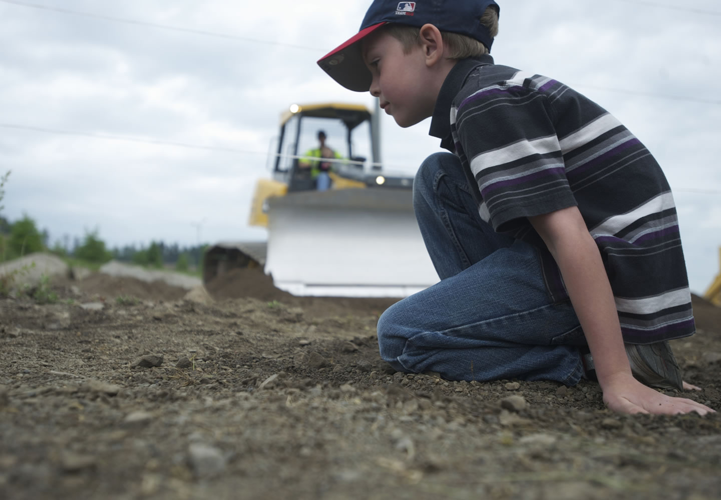 Derek Fechtner, 6, of Woodland, waits patiently in line for his chance to drive a full-sized bulldozer during the annual Dozer Days fundraiser at the Cemex/Fisher Quarry in 2012.