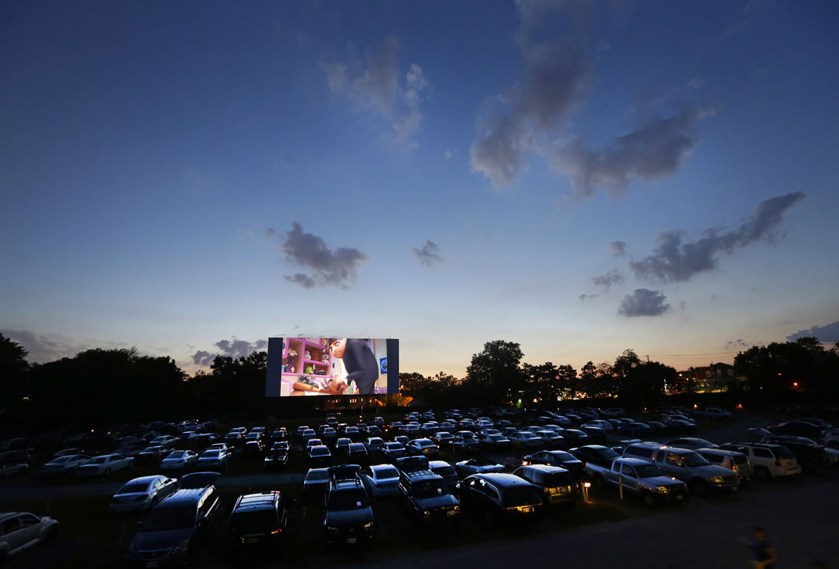 People watch a movie as the sun sets over Bengies Drive-In Theatre in Middle River, Md.