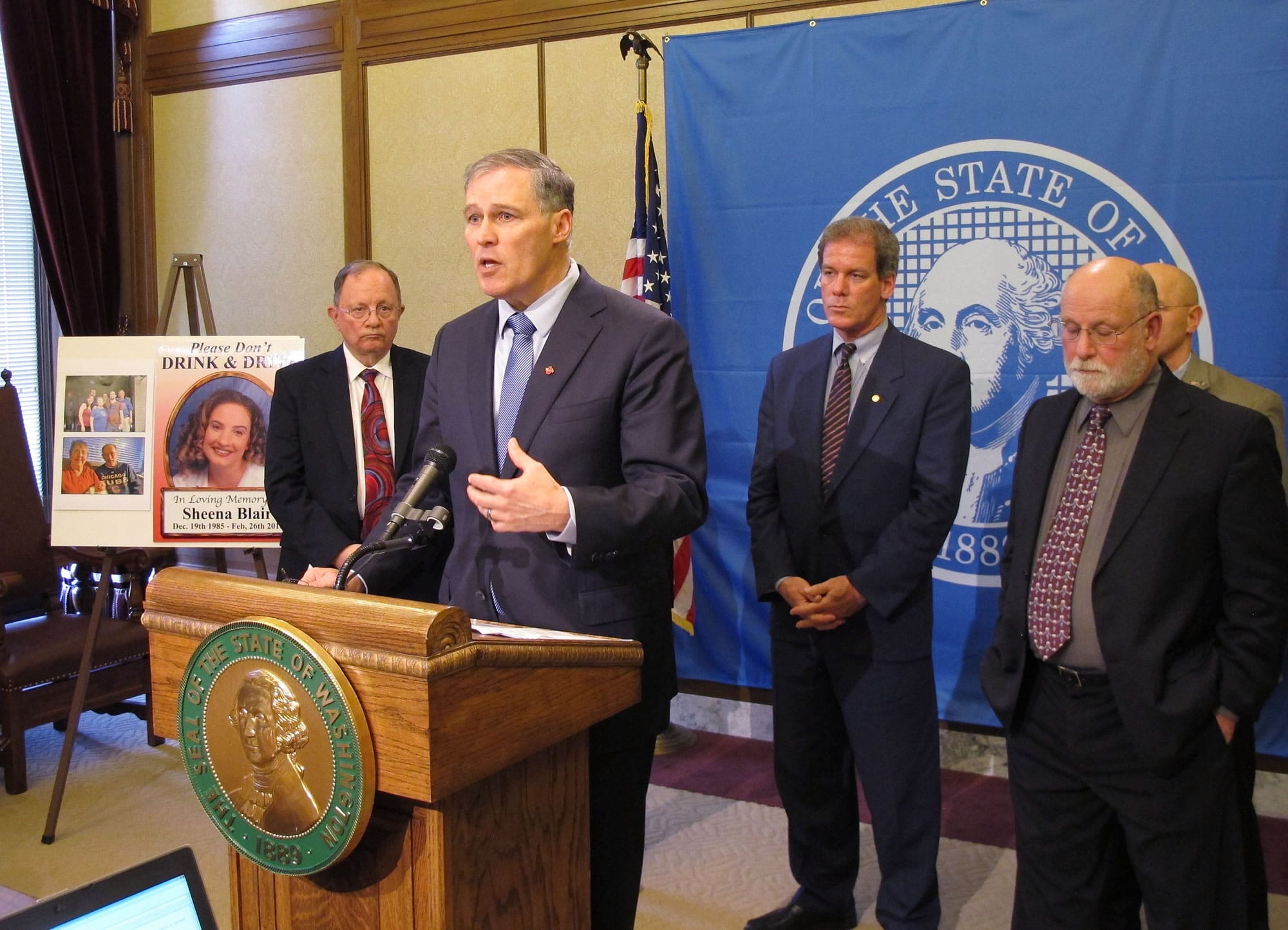 Washington Gov. Jay Inslee, second from left, is joined by lawmakers as he talks to the media about a new proposal for tougher penalties for drunken drivers Tuesday in Olympia.