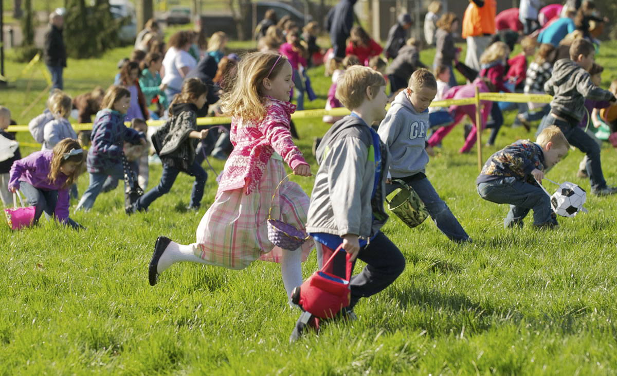 Kids race for eggs during  the start of an Easter egg hunt at Kiwanis Park in Battle Ground.