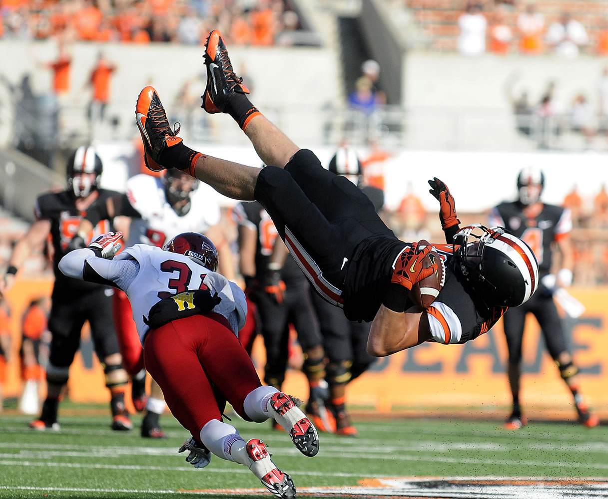 Oregon State's Connor Hamlett (89) flips over Eastern Washington's T.J. Lee (31) while leaping to catch a pass in the third quarter Saturday Aug. 31, 2013 in Corvallis, Ore.