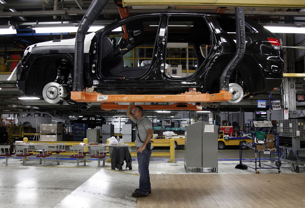 Jeff Caldwell, 29, right, a chassis assembly line supervisor, checks a vehicle on the assembly line at the Chrysler Jefferson North Assembly plant in Detroit.