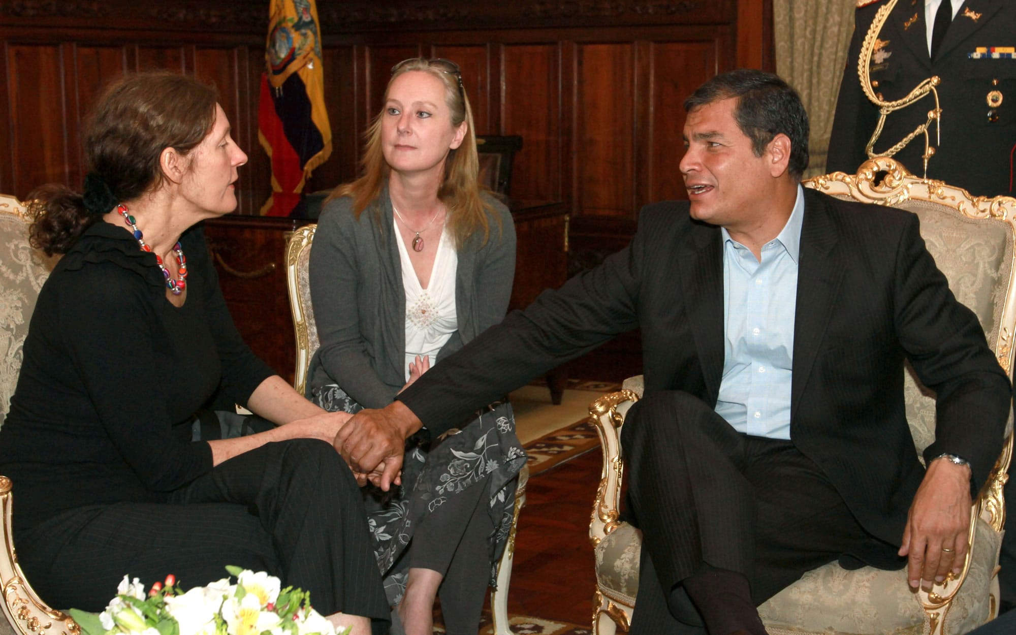 Ecuador's President Rafael Correa, right, holds the hands of Christine Assange, the mother of WikiLeaks founder Julian Assange, during their meeting in Quito, Ecuador.