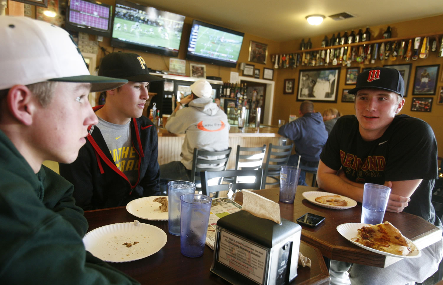 Kyle Reed, right, talks with friends Daulton Hanks, left, and Connor Lau, while being interviewed Dec.
