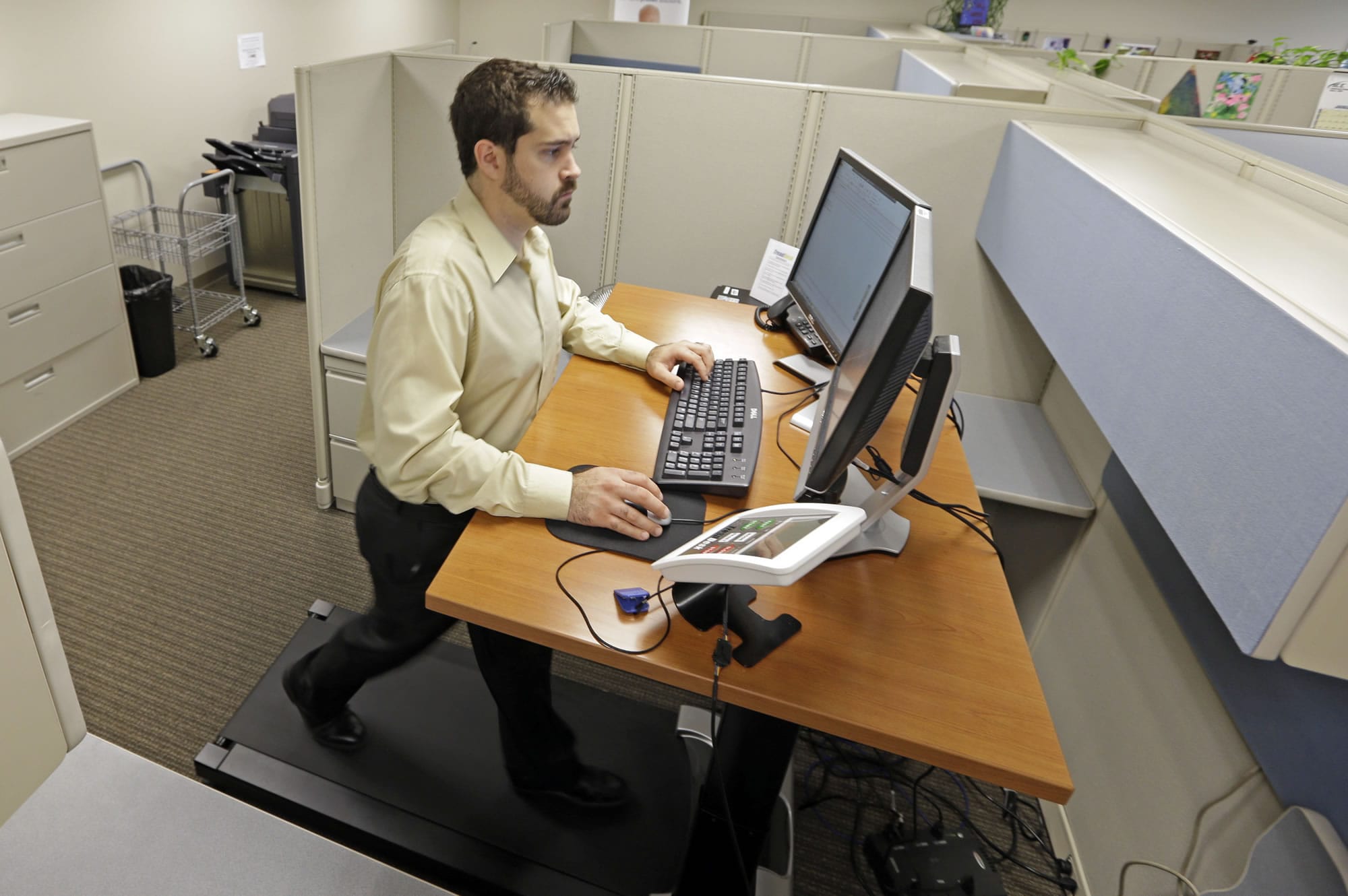 Josh Baldonado, an administrative assistant at Brown &amp; Brown Insurance, works at a treadmill desk in the firm's offices in Carmel, Ind., in August.