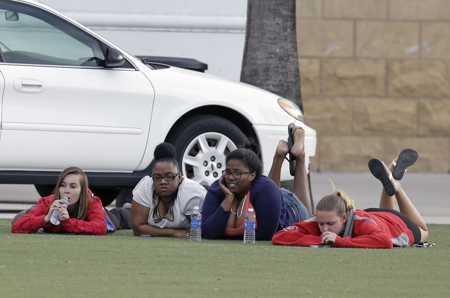 University of Central Florida students wait outside the college sports arena after explosive devices were found in a nearby dorm on Monday in Orlando, Fla.
