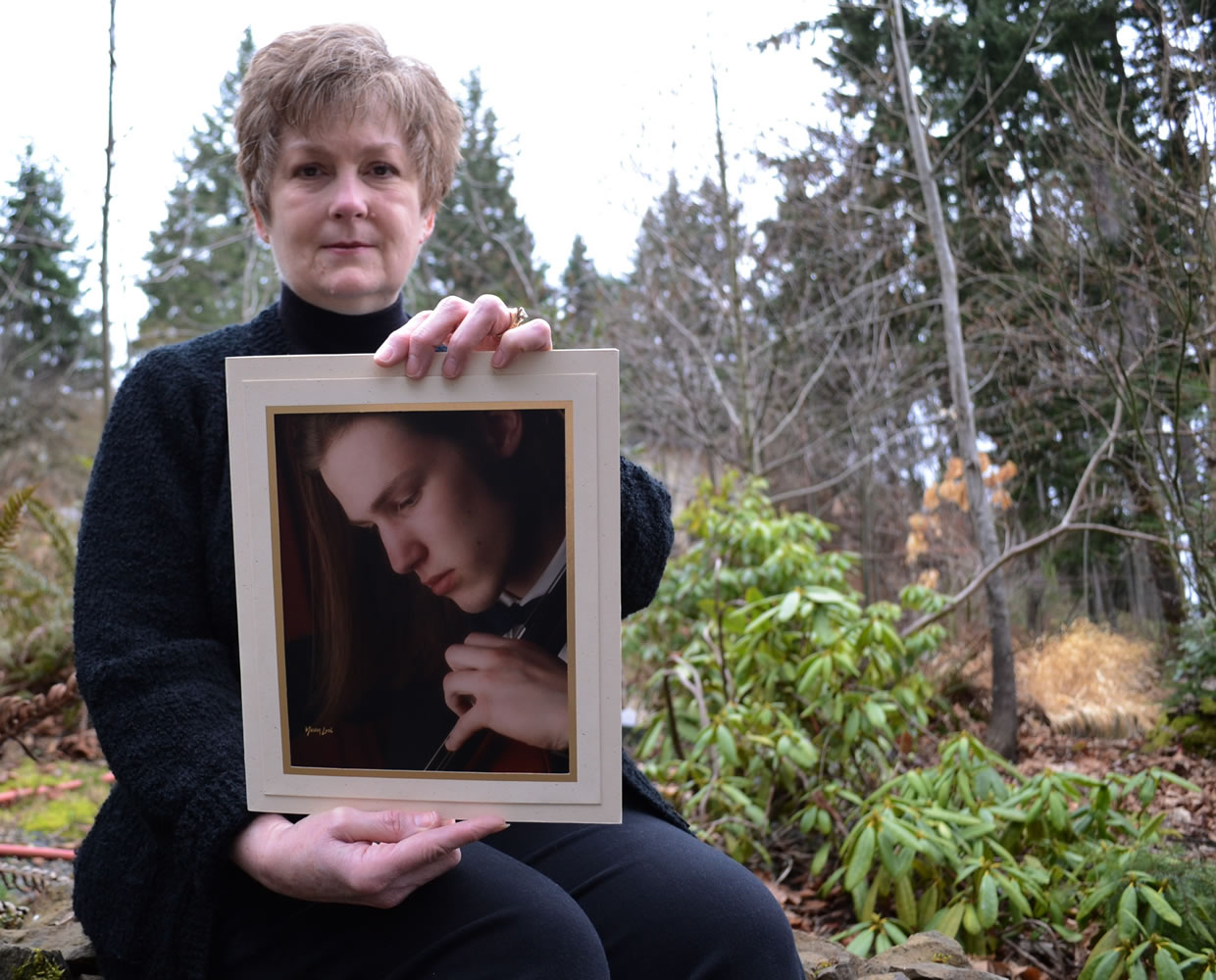 Karen Williams holds a photo of her deceased son, Loren, in Beaverton, Ore.