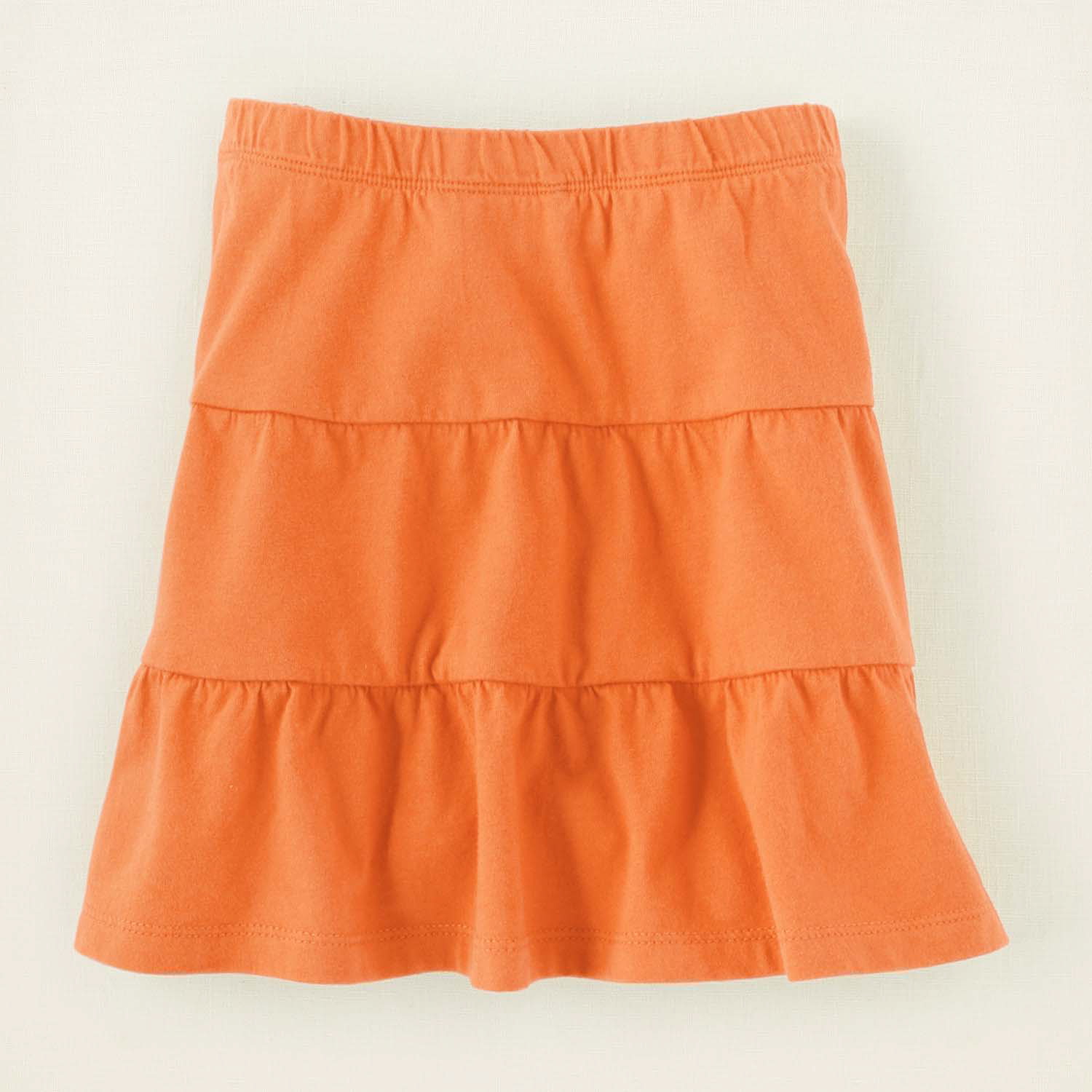 This product image released by The Children's Place shows an orange neon skirt. Unlike so many looks that trickled down from the designer runways into mass retailers and into teenagers' closets, the almost electrifying shades of pink, green, yellow and orange have been hanging out in high school hallways for a while.