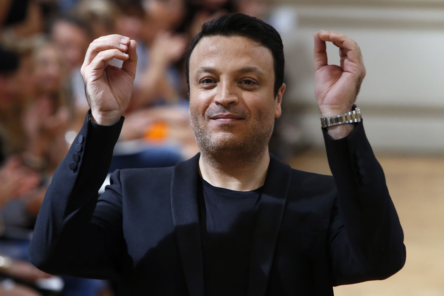 Fashion designer Zuhair Murad gestures at the end of his Haute Couture Fall-Winter 2013-2014 collection show July 4 in Paris.